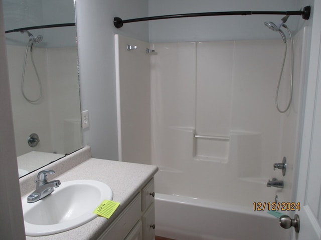 bathroom featuring shower / tub combination and vanity