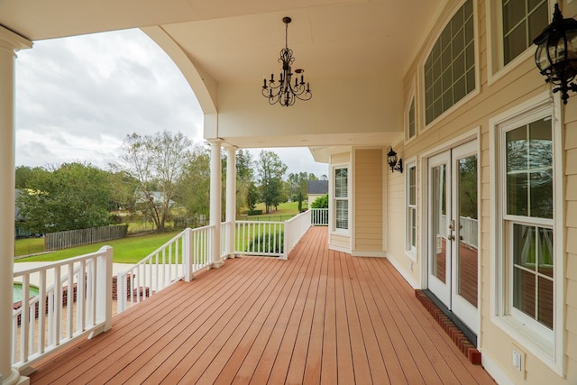 deck featuring a lawn and french doors