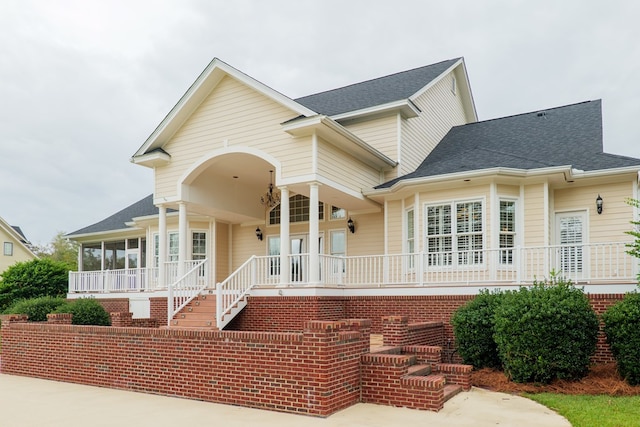 rear view of house featuring a porch