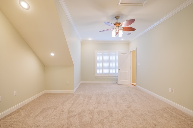 spare room featuring ceiling fan, crown molding, and light carpet