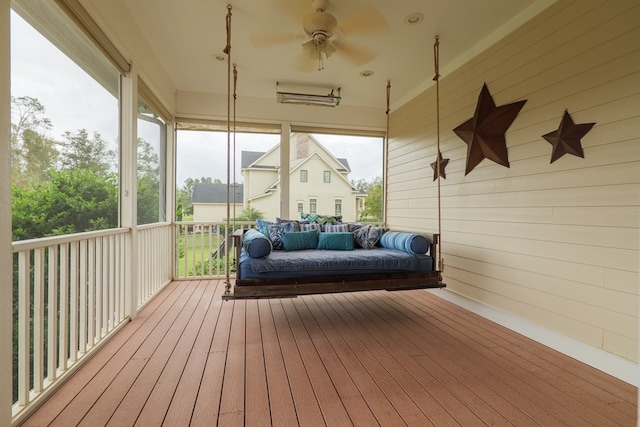 sunroom with ceiling fan