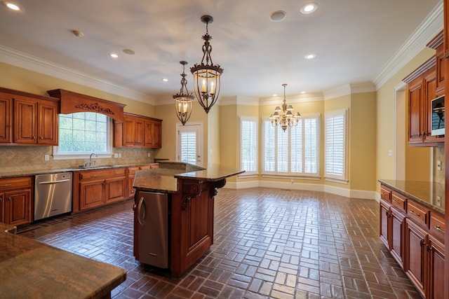 kitchen with an inviting chandelier, a kitchen island, stainless steel dishwasher, and crown molding