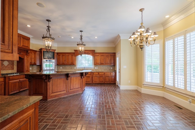 kitchen with a kitchen breakfast bar, stainless steel oven, crown molding, and tasteful backsplash