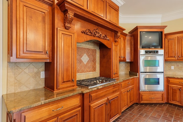 kitchen featuring backsplash, light stone counters, stainless steel appliances, and ornamental molding