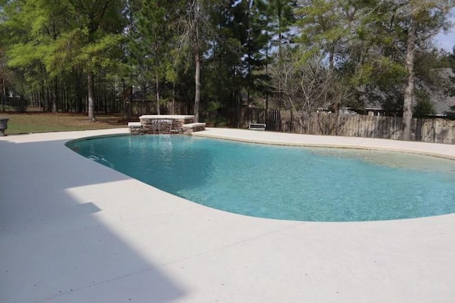 view of pool with a patio area and pool water feature