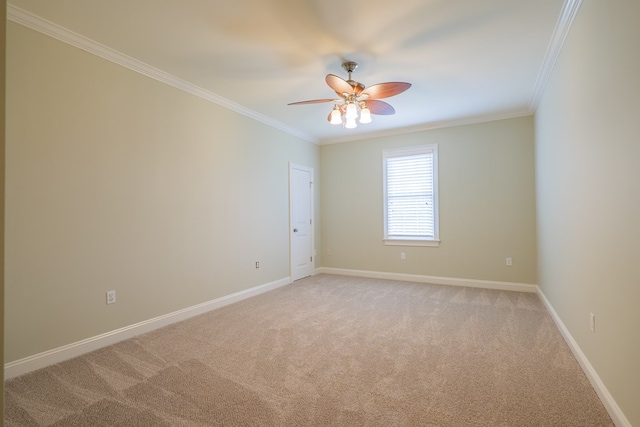 carpeted empty room with ceiling fan and crown molding