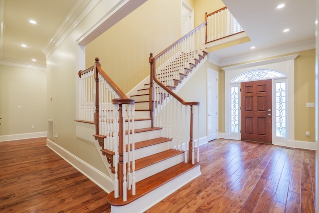 entryway featuring hardwood / wood-style flooring and ornamental molding