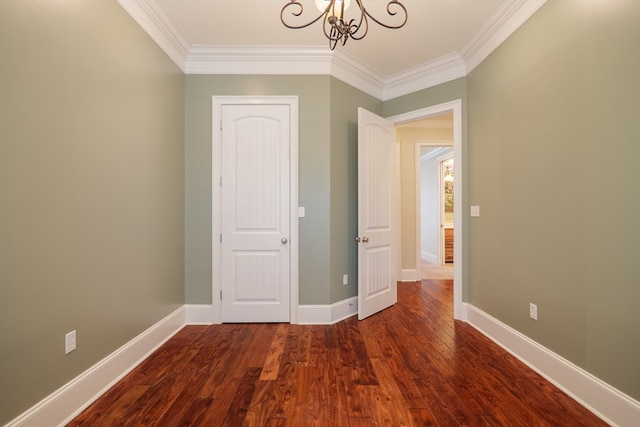 interior space with a chandelier, hardwood / wood-style flooring, and ornamental molding