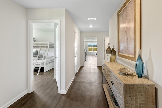 corridor with dark hardwood / wood-style flooring