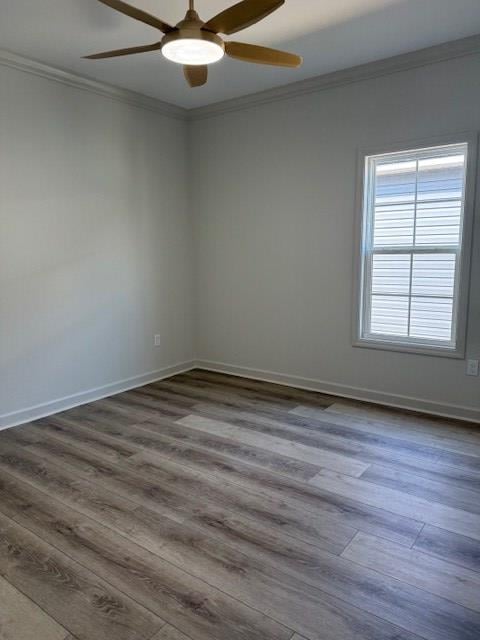 spare room featuring crown molding, hardwood / wood-style floors, and ceiling fan