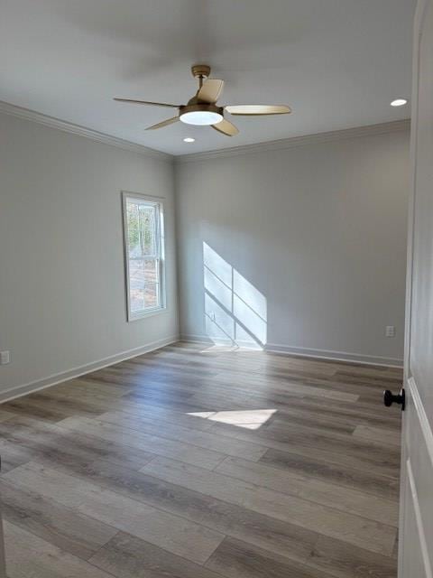 spare room featuring crown molding, ceiling fan, and light wood-type flooring