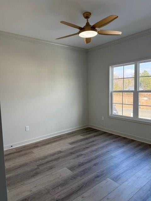 spare room featuring ornamental molding, dark wood-type flooring, and ceiling fan