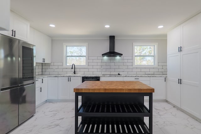 kitchen featuring marble finish floor, wall chimney exhaust hood, smart refrigerator, and a sink