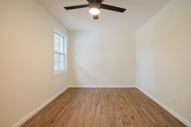 empty room with ceiling fan and hardwood / wood-style flooring