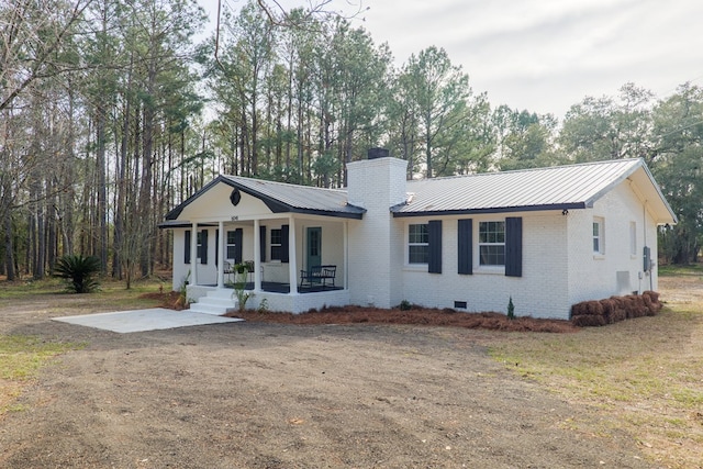 ranch-style home with a front yard, a patio area, and a porch