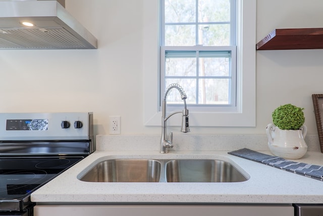 kitchen featuring sink, plenty of natural light, island range hood, and stainless steel range with electric stovetop