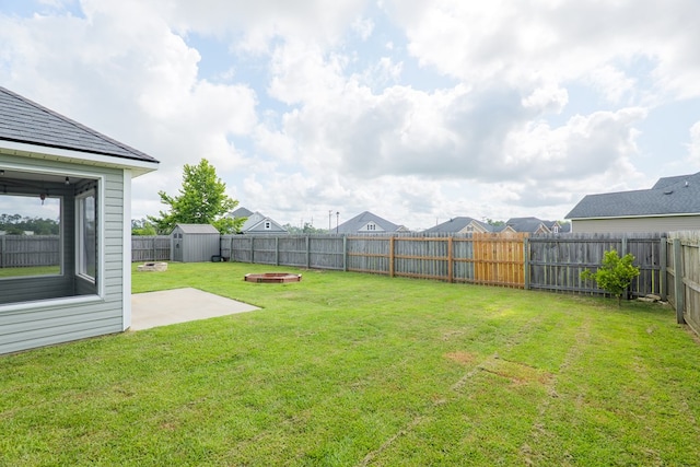 3982 Karaline Cir, Valdosta, GA 31605 - fenced backyard featuring a storage unit, a patio, and an outdoor fire pit