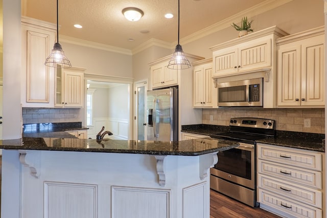3982 Karaline Cir, Valdosta, GA 31605 - kitchen featuring stainless steel appliances, a peninsula, dark stone countertops, ornamental molding, and a textured ceiling