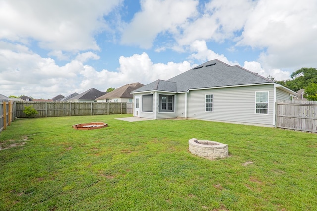 3982 Karaline Cir, Valdosta, GA 31605 - rear view of property with a fire pit and a fenced backyard