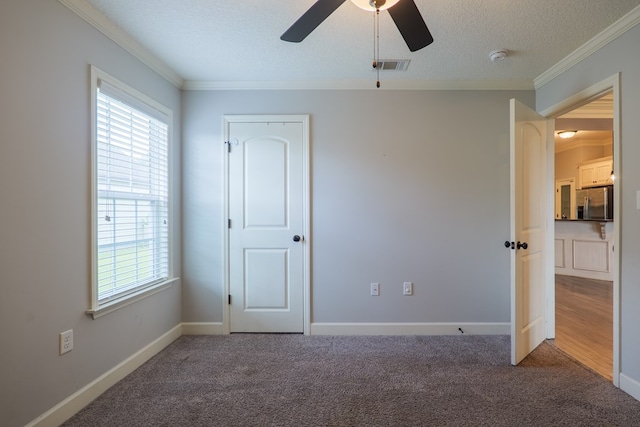 3982 Karaline Cir, Valdosta, GA 31605 - unfurnished bedroom with stainless steel fridge, crown molding, multiple windows, carpet, and a textured ceiling