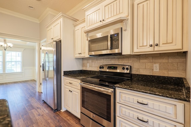 3982 Karaline Cir, Valdosta, GA 31605 - kitchen featuring stainless steel appliances, crown molding, dark wood-type flooring, decorative backsplash, and a chandelier
