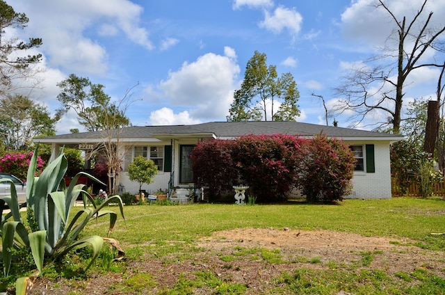 view of front of home with brick siding, a front yard, and entry steps