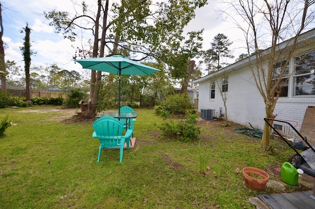 view of yard featuring cooling unit and fence