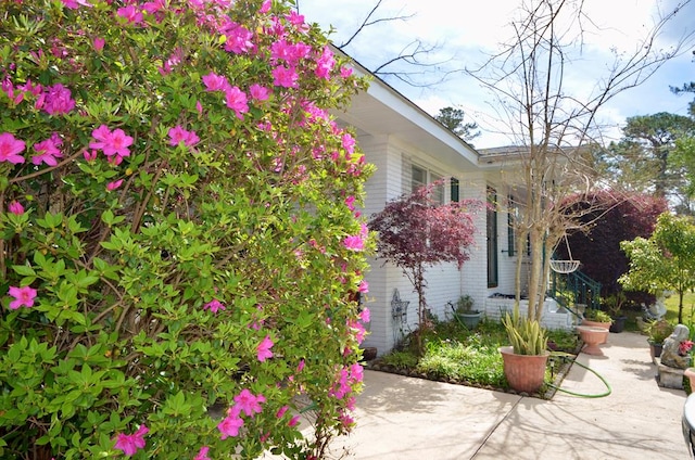 view of side of property with a patio