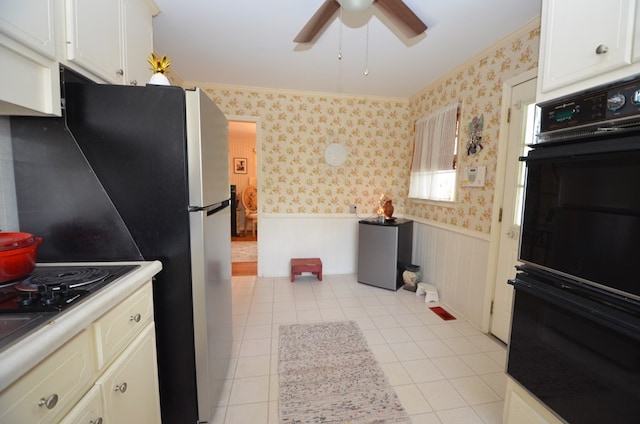 kitchen with ornamental molding, a ceiling fan, wallpapered walls, wainscoting, and light countertops