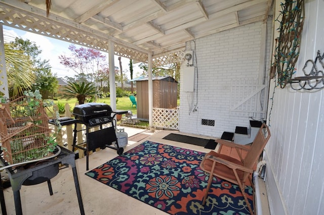 view of patio with an outbuilding, grilling area, and a storage shed