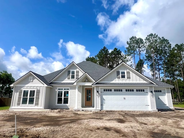 5008 Hatfield Cir, Hahira, GA 31632 - view of front of property featuring board and batten siding, a shingled roof, a garage, and dirt driveway