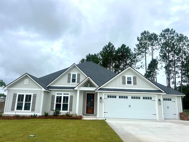 5008 Hatfield Cir, Hahira, GA 31632 - view of front facade featuring board and batten siding, an attached garage, concrete driveway, and a shingled roof
