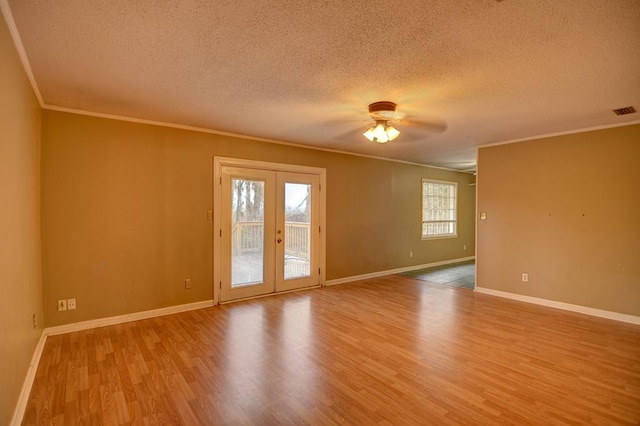 spare room featuring crown molding, french doors, ceiling fan, and light hardwood / wood-style floors