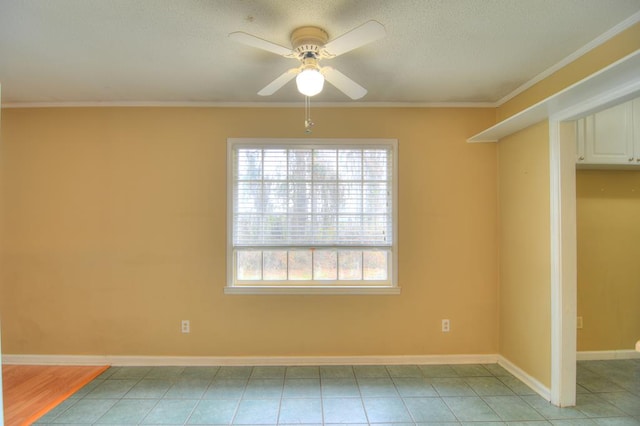 empty room featuring ceiling fan and ornamental molding