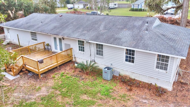 rear view of house featuring central air condition unit and a wooden deck