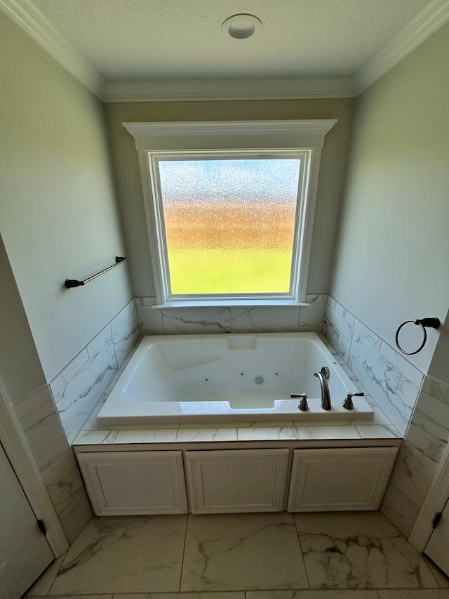 bathroom featuring a relaxing tiled tub, ornamental molding, and a textured ceiling