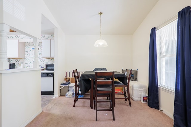 dining area featuring baseboards and light carpet