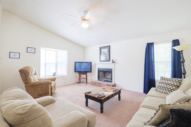 living room with carpet floors, a ceiling fan, and a healthy amount of sunlight