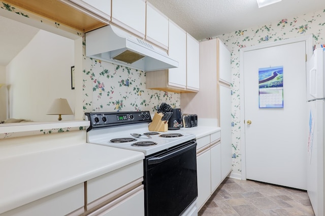 kitchen featuring electric range oven, light countertops, white cabinetry, wallpapered walls, and under cabinet range hood