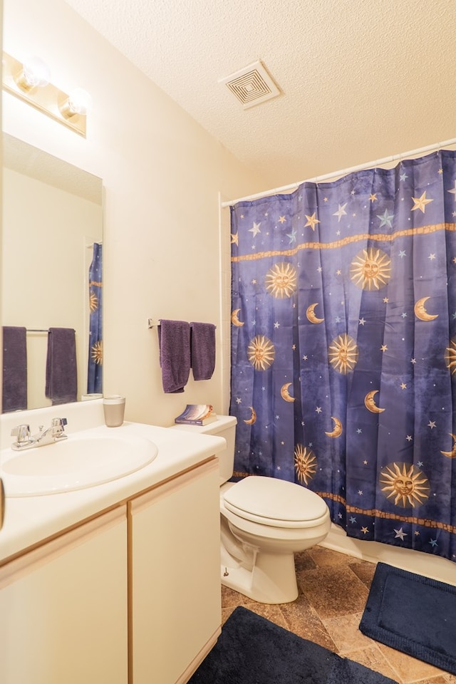 bathroom featuring tile patterned flooring, vanity, toilet, a textured ceiling, and visible vents