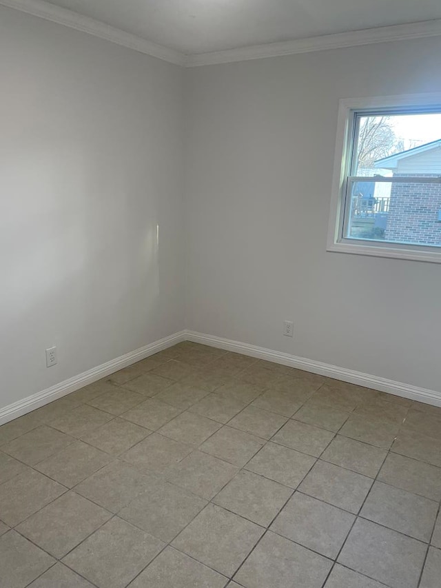 tiled empty room featuring ornamental molding