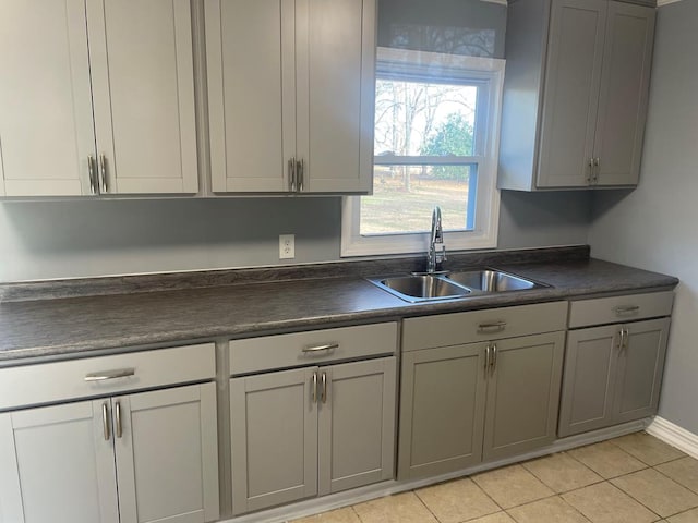 kitchen with sink, gray cabinetry, and light tile patterned floors