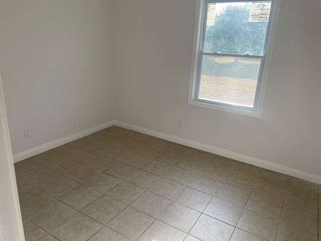 spare room with light tile patterned floors