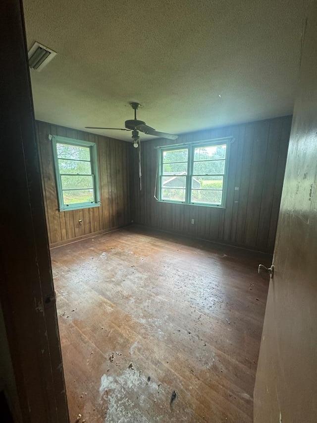 empty room with a healthy amount of sunlight and a textured ceiling