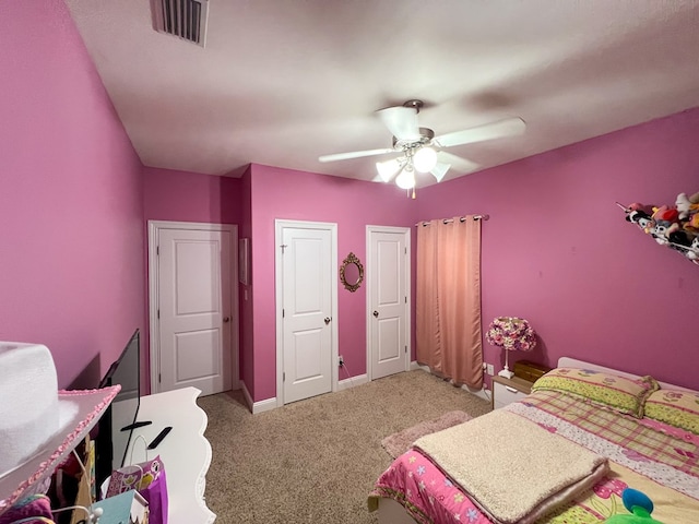 bedroom with a ceiling fan, light colored carpet, visible vents, and baseboards