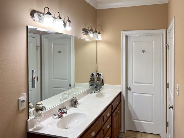 bathroom with double vanity, tile patterned floors, crown molding, and a sink