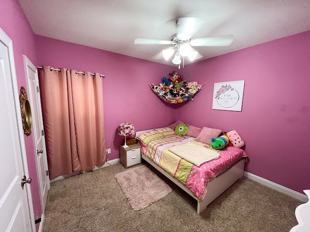 bedroom with a ceiling fan, baseboards, and carpet floors