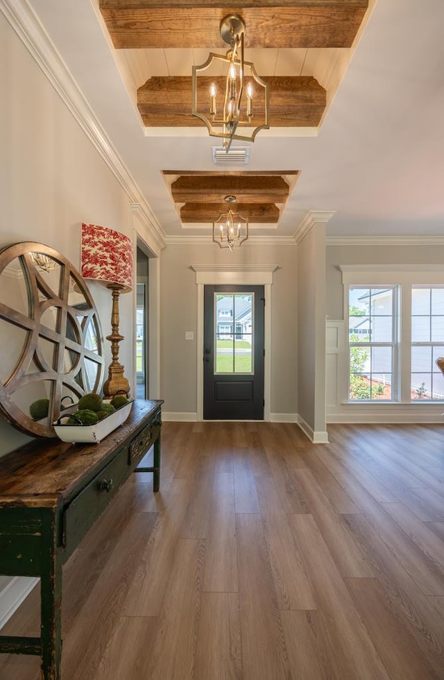 5039 Hatfield Cir, Hahira, GA 31632 - foyer featuring a chandelier, wood finished floors, beamed ceiling, baseboards, and ornamental molding