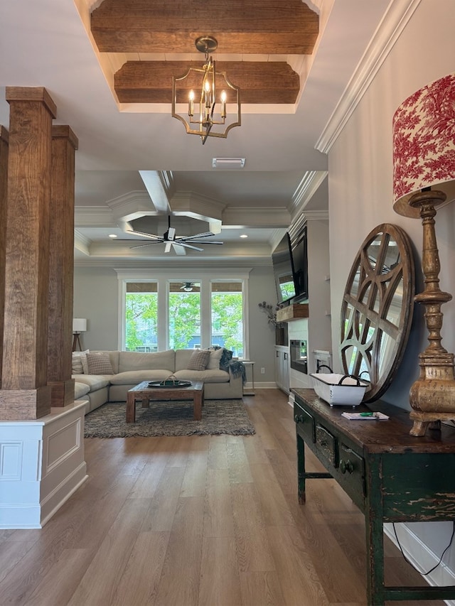 5039 Hatfield Cir, Hahira, GA 31632 - living area featuring a raised ceiling, crown molding, light wood finished floors, a chandelier, and beamed ceiling