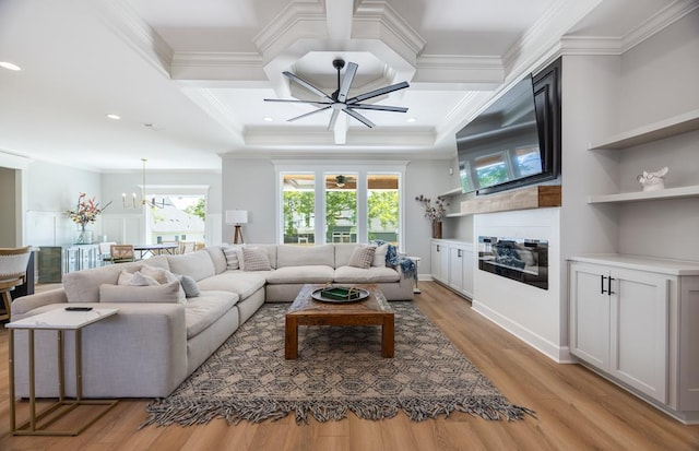 5039 Hatfield Cir, Hahira, GA 31632 - living room featuring a glass covered fireplace, crown molding, coffered ceiling, light wood-type flooring, and ceiling fan